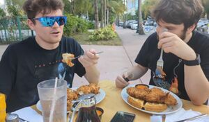 Destiny and Fuentes eating chicken and waffles together.